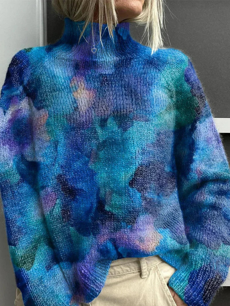 Blue ribbed turtleneck sweater with abstract cloud-like tie-dye pattern