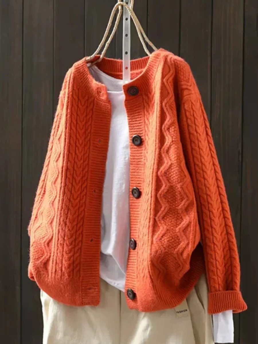 Orange cable-knit cardigan with button front and textured knit sleeves