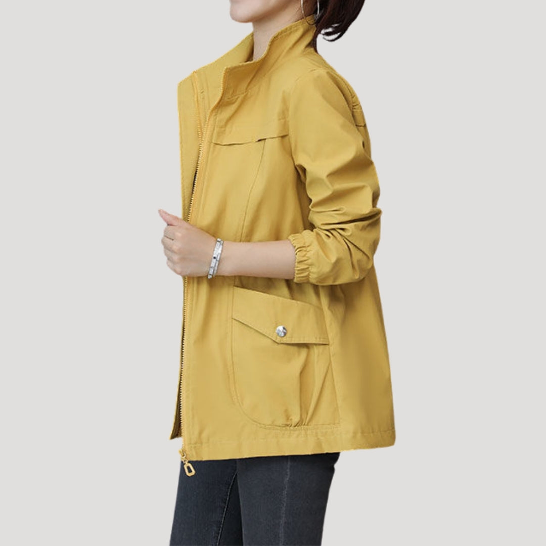 Mustard yellow women’s zip-front windbreaker with flap pockets and elastic cuffs