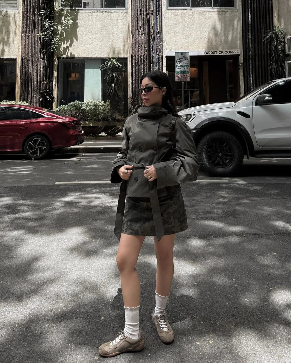 Army green cropped trench coat with button front and belted waist