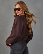 Wine crewneck knit sweater in a relaxed fit, shown from the side
