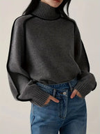 Dark gray turtleneck knit sweater with ribbed cuffs and straight hem