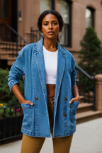 Light blue denim blazer with notched collar, two-button front, chest and side pockets