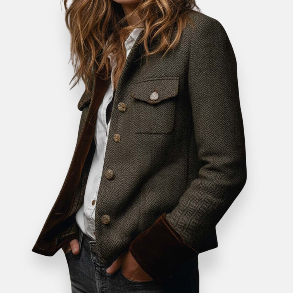 Dark herringbone tweed jacket with buttoned chest pocket and flap sleeve trim