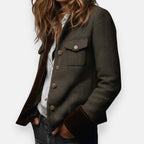 Dark herringbone tweed jacket with buttoned chest pocket and flap sleeve trim