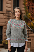 Heather gray knit sweater with pink and green fair isle pattern and ribbed cuffs.