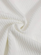 White ribbed knit polo fabric on a long-sleeve top, close-up texture