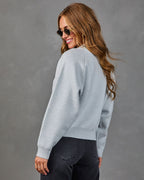 Heather grey crewneck knit sweater, shown from the side with relaxed shoulders