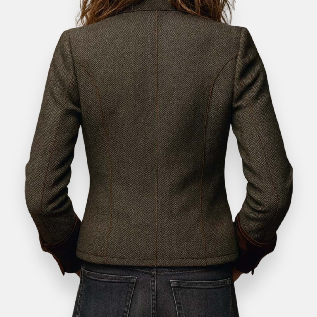 Back view of dark herringbone tweed jacket with fitted seams and cuffs