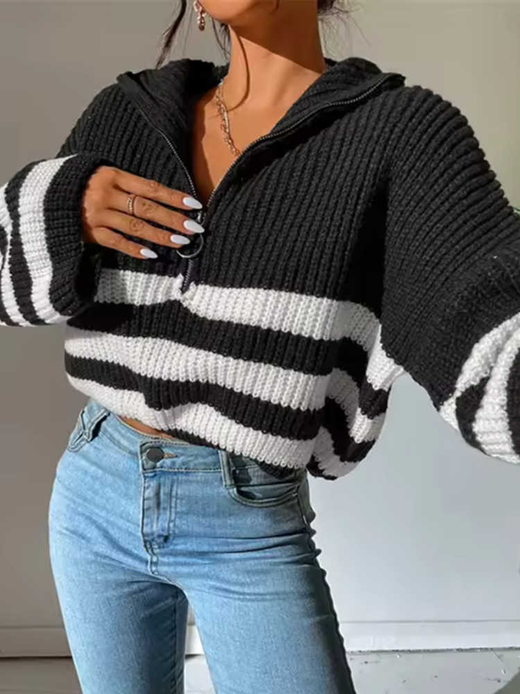 Black half-zip knit sweater with black-and-white horizontal stripes and ribbed cuffs