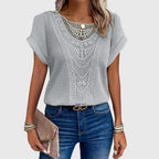 Light gray crochet blouse with lace-like yoke and short flutter sleeves