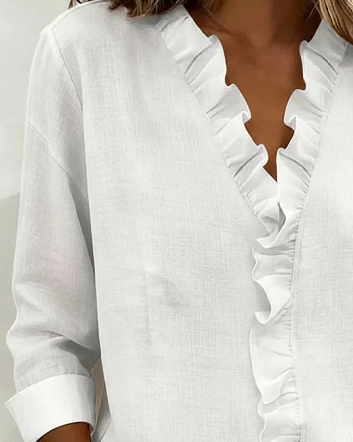 White ruffle-trim V-neck blouse with long sleeves