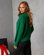 Green mock neck sweater with long sleeves and ribbed cuffs