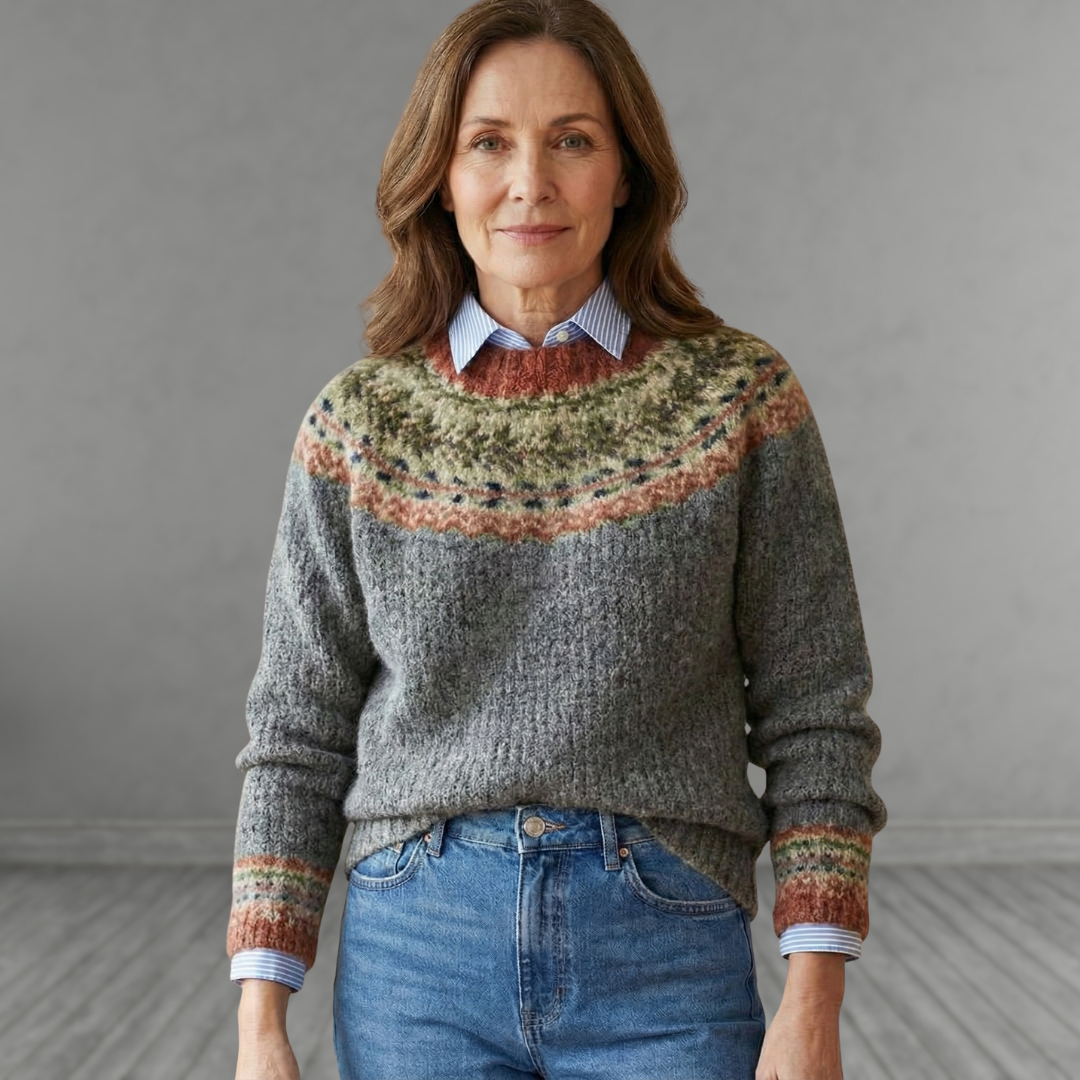 Gray knit sweater with multicolor fair isle yoke, ribbed cuffs, and crew neckline.