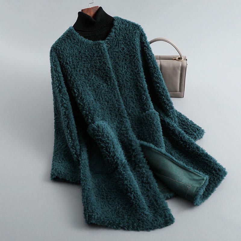 Teal shearling coat with ribbed black turtleneck, long sleeves, open front lining