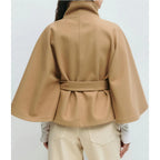 Women's high-collar cape coat in tan, back view with belt tie