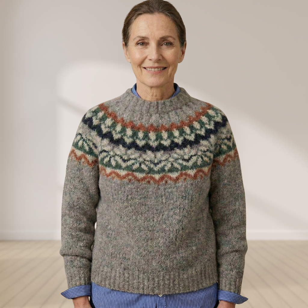 Gray knit sweater with Nordic fair isle yoke in dark green, orange, and cream tones.