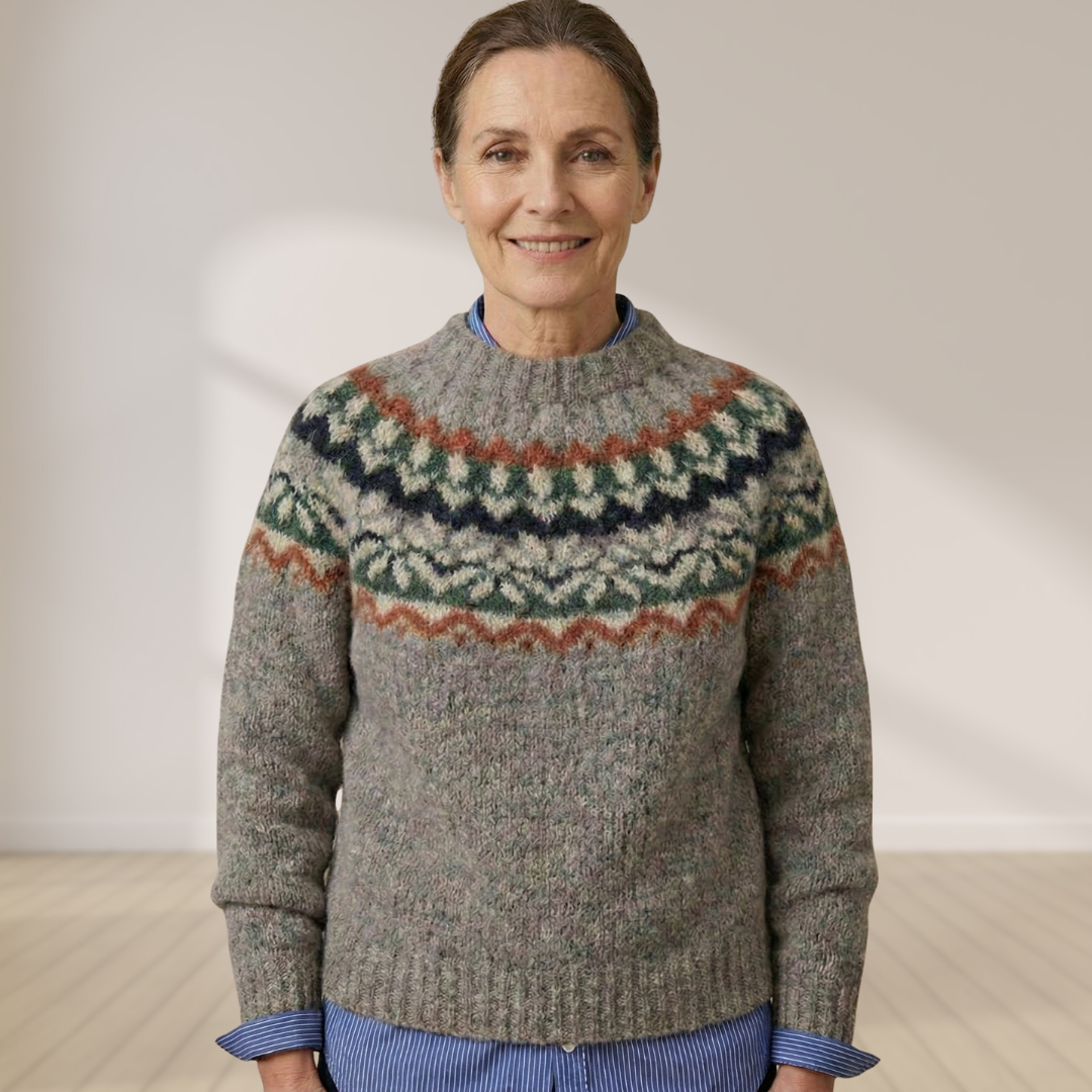 Gray knit sweater with Nordic fair isle yoke in dark green, orange, and cream tones.