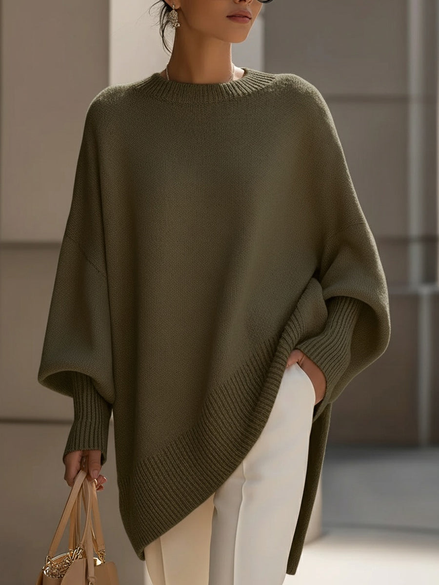 Olive green oversized knit poncho with ribbed crew neck and relaxed drop sleeves