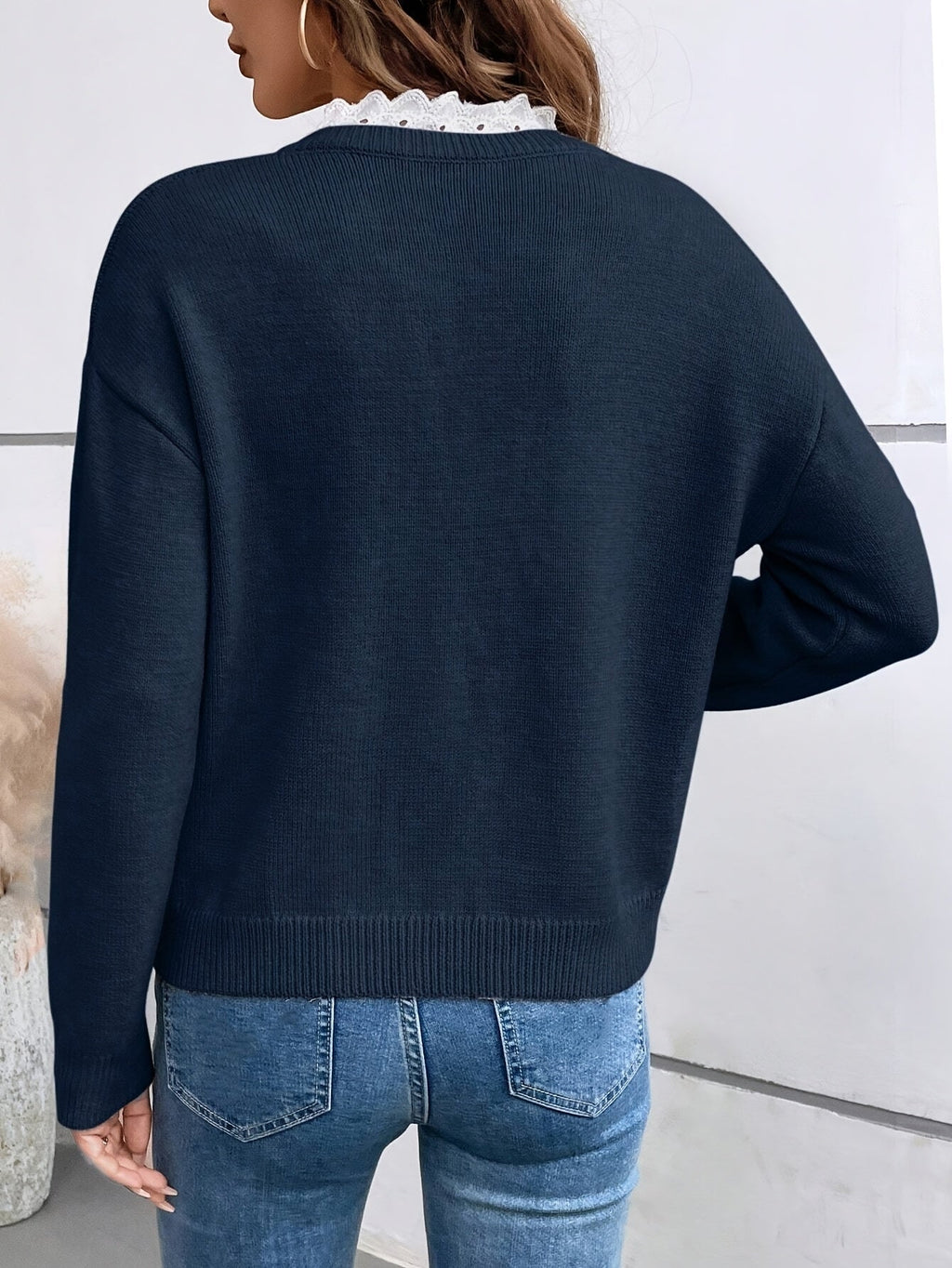 Dark blue French-collar knit blouse with ruffled V neckline and long sleeves