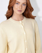 Cream button-front knit cardigan with round neck and front buttons, long sleeves