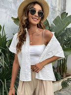 White cotton short-sleeve button-up shirt worn open with pointed collar