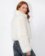 White cropped faux fur jacket with high collar and long sleeves; left side view