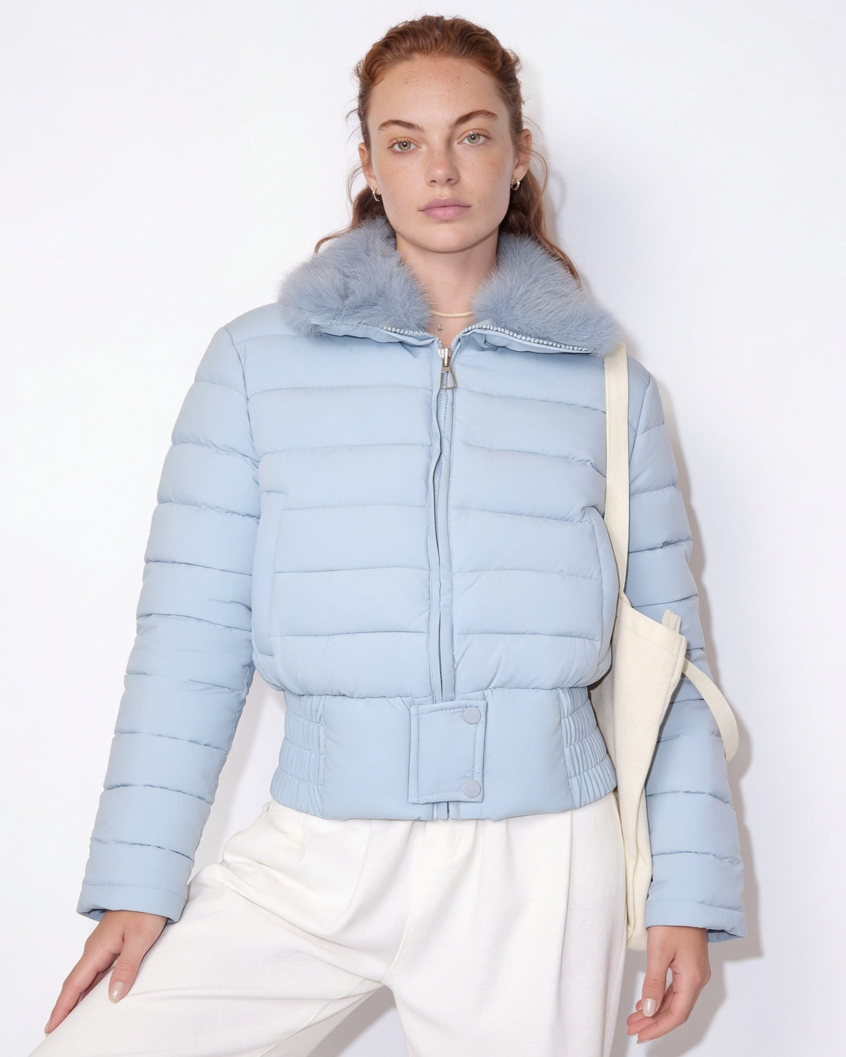 Light blue cropped puffer jacket with faux fur collar and zip front