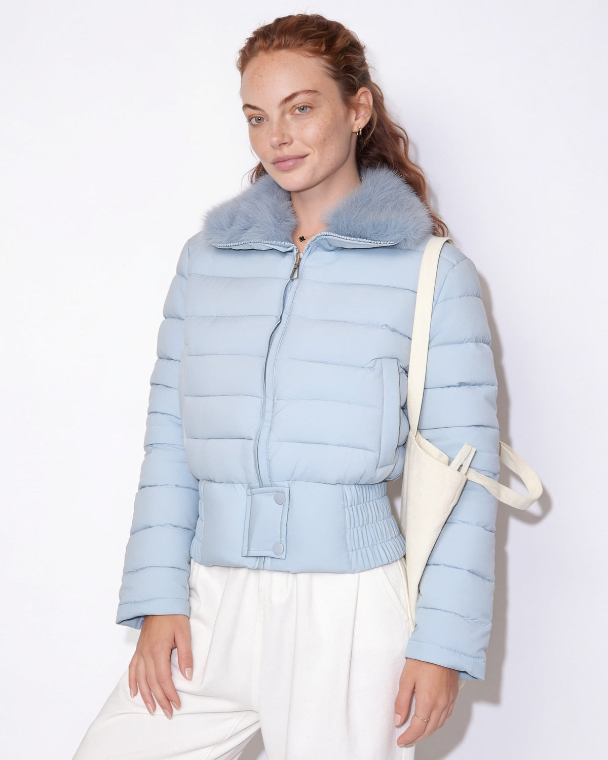 Light blue cropped puffer jacket with faux fur collar, front zipper, elastic waist