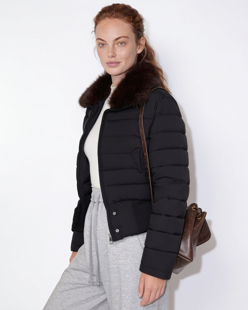 Black cropped puffer jacket with faux fur collar and full-length sleeves