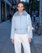 Light blue cropped puffer jacket with faux fur collar, front zipper, long sleeves