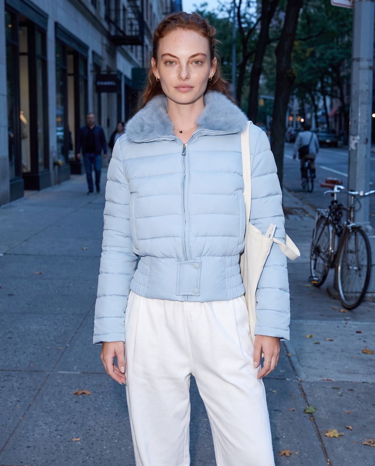 Light blue cropped puffer jacket with faux fur collar, front zipper, long sleeves