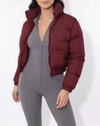 Burgundy cropped puffer jacket close-up with funnel collar and zip front