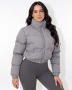 Cropped funnel-collar puffer jacket in light grey, full-zip front, long sleeves