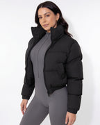 Black cropped puffer jacket with funnel collar and zip front, long sleeves