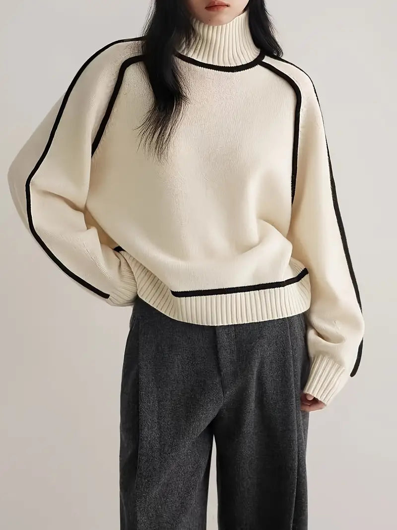 Cream turtleneck knit sweater with black piping details and ribbed hem