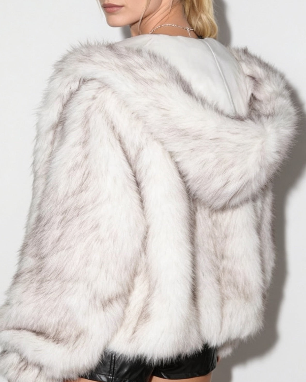 Off-white faux fur hooded jacket close-up, hood drape and soft fur texture.