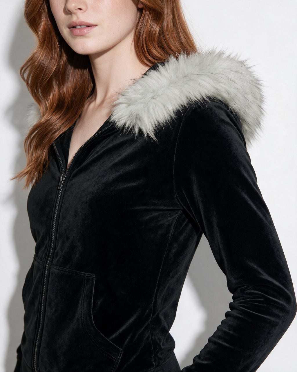 Black velvet hooded jacket close-up with light faux fur trim and zipper