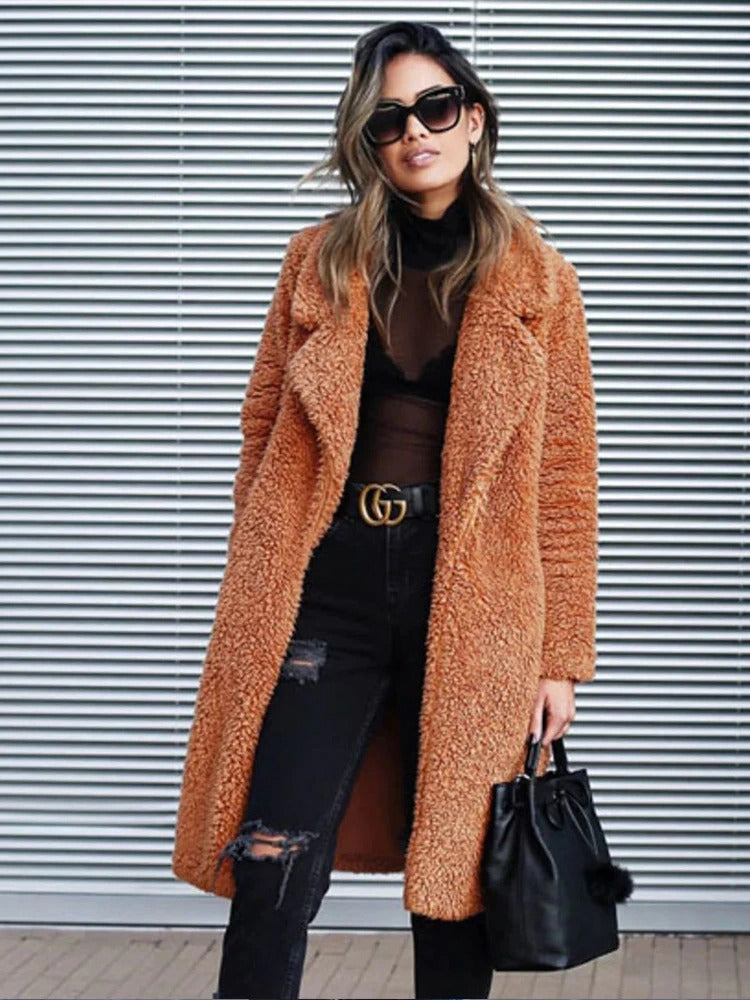 Soft long teddy fleece coat in warm orange-brown, relaxed open front with lapels.