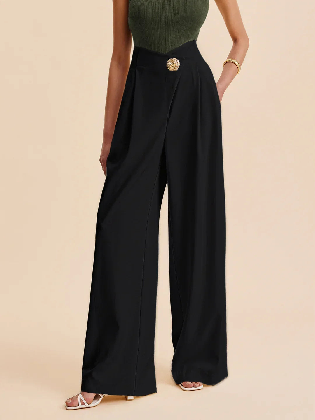 Black wide-leg tailored pants with gold button waistband and pleated front