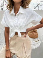 White short-sleeve cotton button-up shirt with chest pocket, tied at the waist