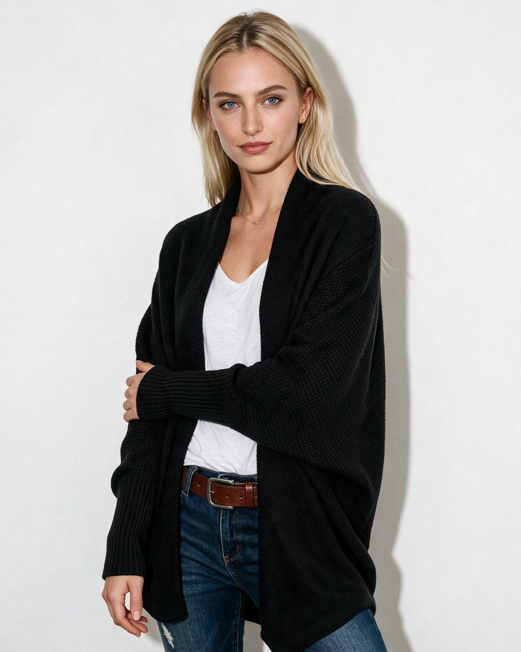 Women’s longline open-front cardigan with dolman sleeves, black textured knit.