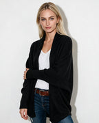Women’s longline open-front cardigan with dolman sleeves, black textured knit.
