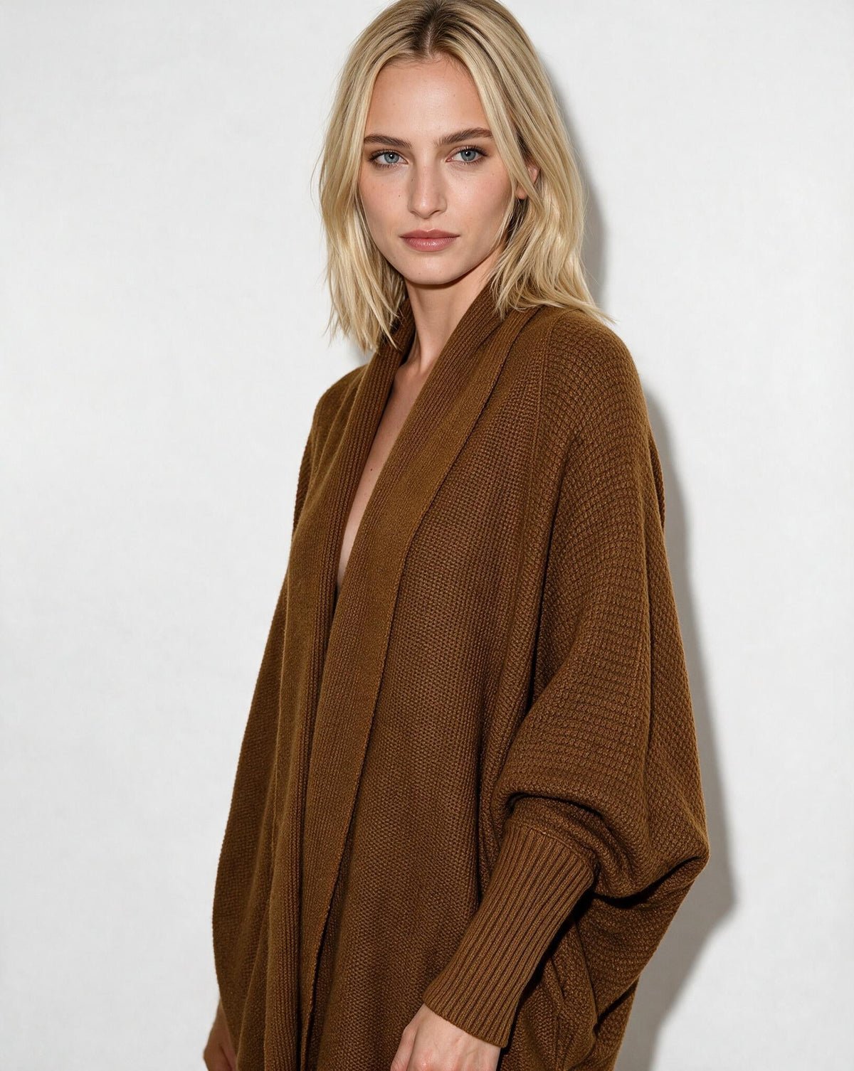 Women’s longline open-front cardigan with dolman sleeves, brown knit with ribbed cuffs.