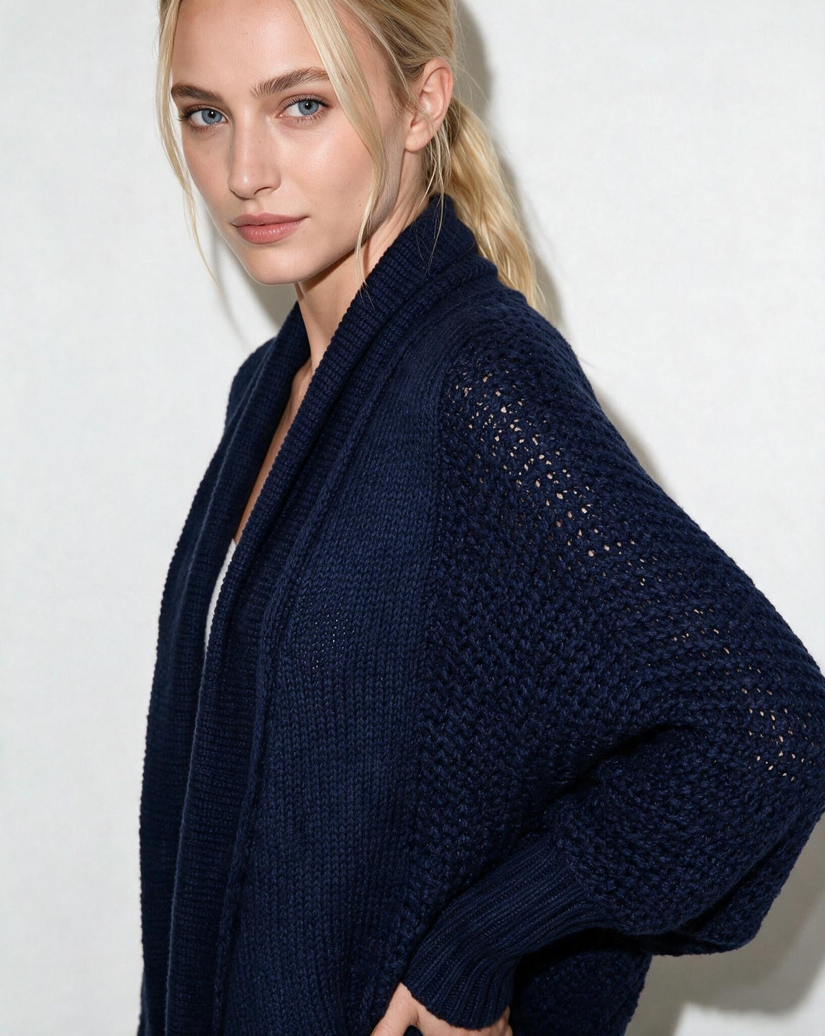 Navy open-front cardigan with dolman sleeves and textured knit on shoulders