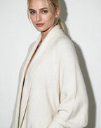 Women’s longline open-front cardigan with dolman sleeves, cream textured knit.