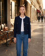 Women’s navy cropped collarless jacket, button front and four flap pockets with gold buttons.