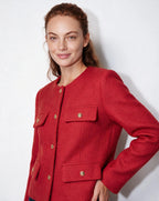 Cropped collarless red jacket with gold buttons and four flap pockets detail