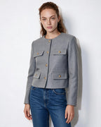 Women’s grey cropped collarless jacket, gold button front with four flap pockets.