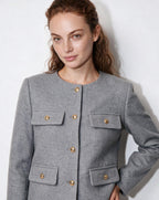 Cropped collarless jacket in grey with gold buttons and four flap pockets